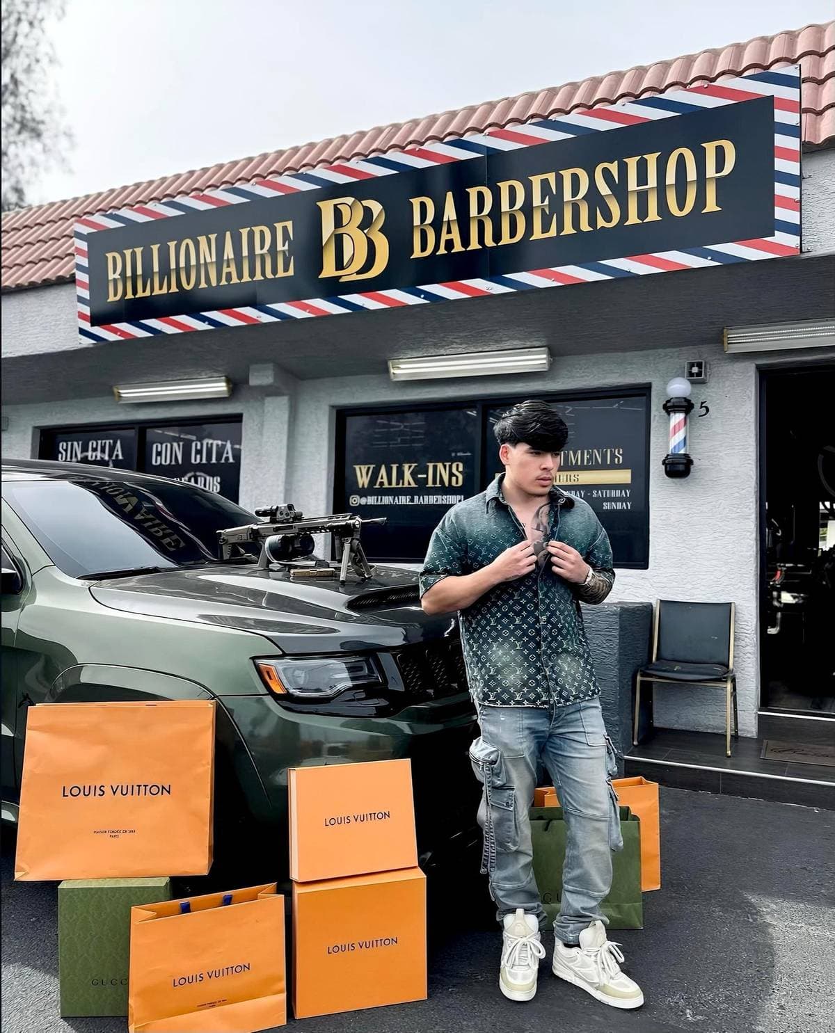Joel Da Barber in front of Billionaire Barbershop with Louis Vuitton and his Trackhawk